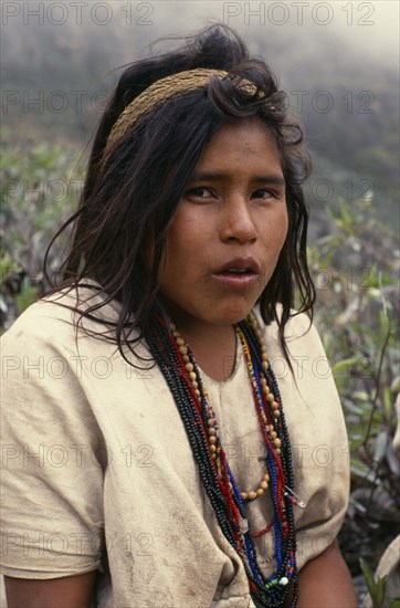 COLOMBIA, Sierra Nevada de Santa Marta, Ika, Portrait of Ika shepherd girl in the high pastures of the Sierra. Strings of coloured glass beads denote family wealth Arhuaco Aruaco indigenous tribe American Colombian Colombia Female Lady Hispanic Indegent Latin America Latino South America  Arhuaco Aruaco indigenous tribe American Colombian Columbia Hispanic Indegent Latin America Latino South America Farming Agraian Agricultural Growing Husbandry  Land Producing Raising Immature One individual Solo Lone Solitary 1 Agriculture Colored Single unitary Young Unripe Unripened Green