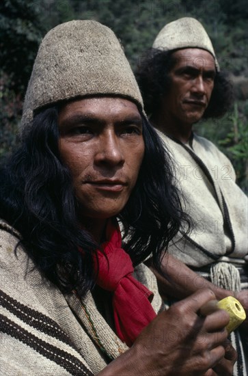 COLOMBIA, Sierra Nevada de Santa Marta, Ika, Head and shoulders portrait of two Ika men in traditional dress. Helmets made from fique cactus fibre and mantas cloaks from woven wool&cotton. Both members of the powerful Villafana family Arhuaco Aruaco indigenous tribe American Classic Classical Colombian Colombia Hispanic Historical Indegent Latin America Latino Male Man Guy Older South America  Arhuaco Aruaco indigenous tribe American Classic Classical Colombian Columbia Hispanic Historical Indegent Latin America Latino Male Man Guy Older South America 2 History Male Men Guy Fiber
