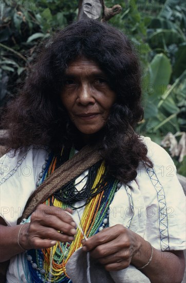 COLOMBIA, Sierra Nevada de Santa Marta, Ika, Portrait of Ika woman  one of the powerful Villafana family living in the Guatapuri river valley on the South side of the Sierra. Wearing multiple necklaces of brightly coloured glass beads  a sign of wealth. Arhuaco Aruaco indigenous tribe  Arhuaco Aruaco indigenous tribe American Colombian Colored Columbia Female Women Girl Lady Hispanic Indegent Latin America Latino One individual Solo Lone Solitary South America 1 Female Woman Girl Lady Single unitary