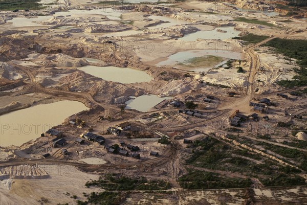 BRAZIL, Mato Grosso, Peixoto de Azevedo, Gold mine on former Panara territory showing miners settlement and mercury washing pools  deforestation and pollution.Garimpeiro                      prospectors have displaced the Panara  formerly known as Kreen-Akrore  Krenhakarore  Krenakore  Krenakarore  Amazon American Brasil Brazilian Ecology Entorno Environmental Environment Green Issues Kreen Akore Latin America Latino Scenic South America