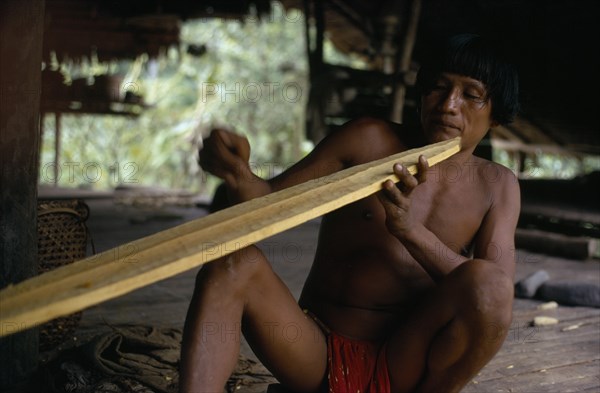 COLOMBIA, Choco, Embera Indigenous People, Embera family head  Heraklio  finely shaping wooden canoe paddle at riverside home on rio Baudo  Pacific coastal region boat oar tribe American Colombian Colombia Hispanic Indegent Latin America Latino Male Men Guy South America  Pacific coastal region boat oar tribe American Colombian Columbia Hispanic Indegent Latin America Latino Male Men Guy South America Male Man Guy One individual Solo Lone Solitary 1 Single unitary