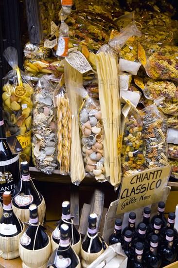 ITALY, Tuscany, San Gimignano, Shop display of a variety of colourful pastas and Chianti wines