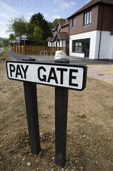 ENGLAND, West Sussex, Washington, To Let signs on wooden fencing outside a newly built housing development in a road called Pay Gate