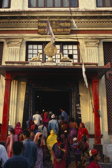 NEPAL, Kathmandhu Valley, Swayambhunath, Buddhist pilgrims at temple stupa entrance.