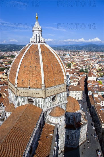 ITALY, Tuscany, Florence, "The Dome of the Cathedral of Santa Maria del Fiore, the Duomo, by Brunelleschi with tourists on the viewing platform looking over the city towards the surrounding hills"