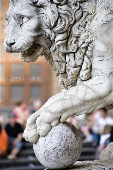 ITALY, Tuscany, Florence, "Sculpture of a lion with its paw on a cannon ball at the entrance to the Loggia del Lancia, or Loggia di Orcagna named after the architect"