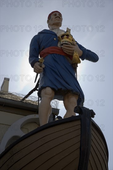 ENGLAND, West Sussex, Shoreham-by-Sea, Exterior of the Crown and Anchor public house in the high street with ships mast head figure in the fonrt of the building.