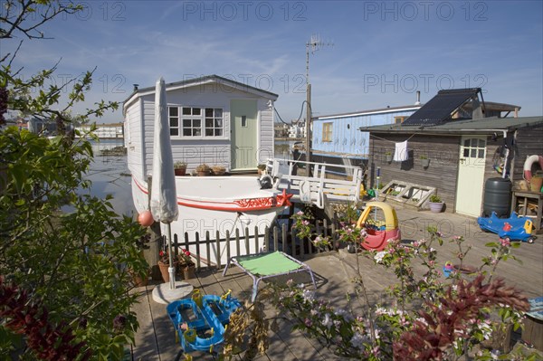 ENGLAND, West Sussex, Shoreham-by-Sea, Houseboat moored along the banks of the river adur.  Former barges and old boats converted into homes .