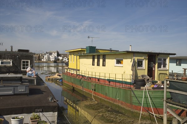 ENGLAND, West Sussex, Shoreham-by-Sea, Houseboat moored along the banks of the river adur.  Former barges and old boats converted into homes .