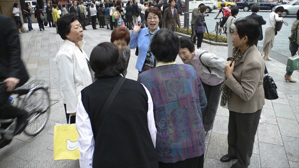 JAPAN, Honshu, Tokyo, "Ginza - group of middle-aged women saying goodbye, well dressed, courtesy bows to each other"