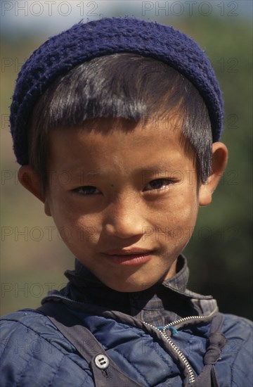 NEPAL, Annapurna Region, Bhadauri, Head and shoulders portrait of young Gurung boy in Bhadauri village