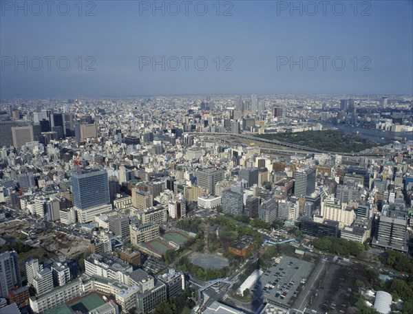 JAPAN, Honshu, Tokyo, "Cityscape from Tokyo Tower with high rise buildings, car park, sports courts and building site."