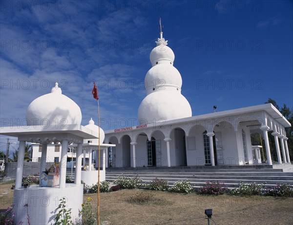 MAURITIUS, East Coast, Religion, "Hindu temple exterior with steps to colonnaded entrance and white, three dome spire above.  Small kiosks with statues in foreground."