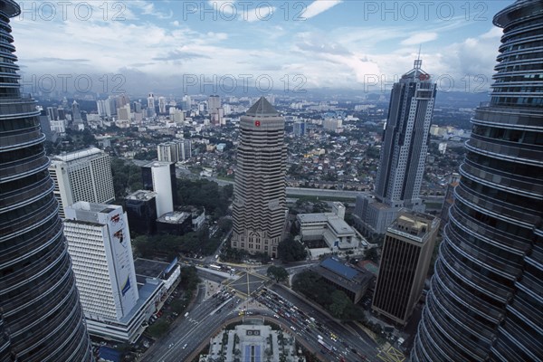 MALAYSIA, Kuala Lumpur, Elevated view over city framed by the Petronas Towers.