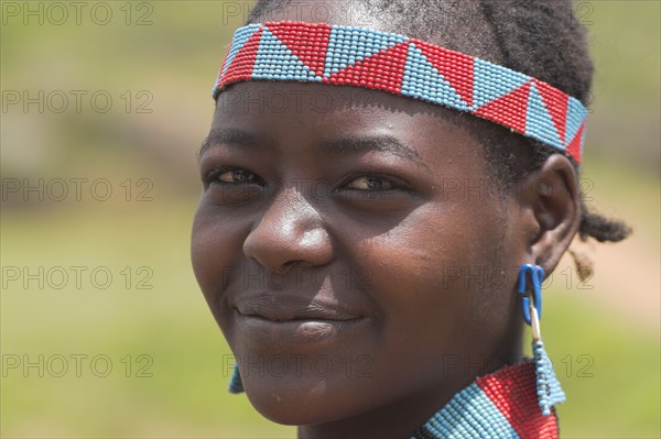 ETHIOPIA, Lower Omo Valley, Key Afir, Tsemay woman at weekly market.