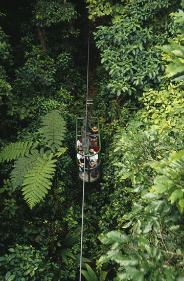 COSTA RICA, Landscape, Rainforest, Tourists in aerial tram through rainforest near Braulio Carillo National Park.