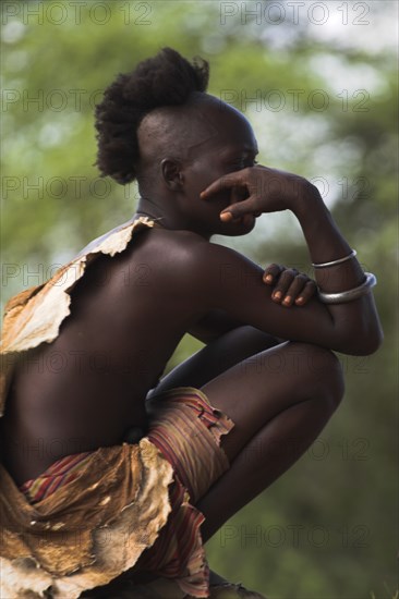 ETHIOPIA, Lower Omo Valley, Tumi, "Hama Jumping of the Bulls initiation ceremony, the initiate comtemplates the ceremony where he will be required to 'jump' over a line of bulls"