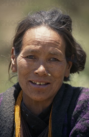 NEPAL, Lower Dolpo Trek, Bhang Kharka, Head and shoulders portrait of a woman wearing a nose piercing