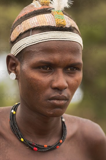 ETHIOPIA, Lower Omo Valley, Village near Omorate, Dassanech man.