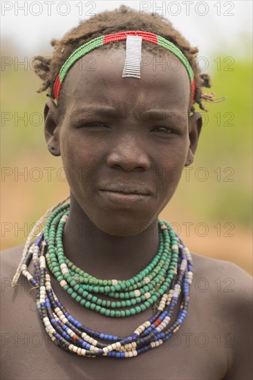 ETHIOPIA, Lower Omo Valley, Village near Omorate, Dassanech girl