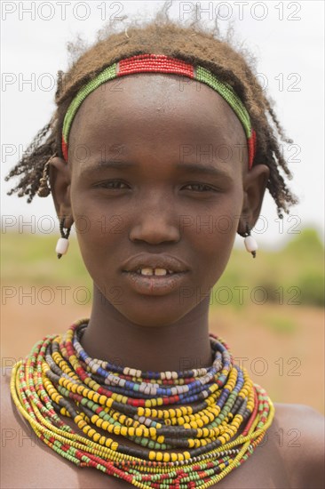 ETHIOPIA, Lower Omo Valley, Village near Omorate, Dassanech girl