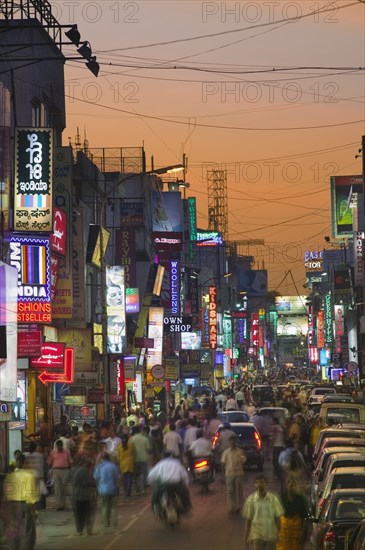 INDIA, Karnataka, Bangalore, Commercial Street at dusk.