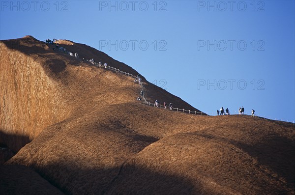 AUSTRALIA, Northern Territory, Uluru, "Kata Tjuta National Park, Mount Uluru, People climbing  Ayers Rock."