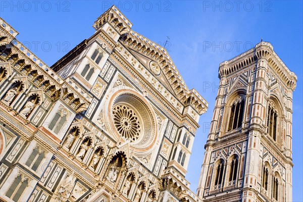 ITALY, Tuscany, Florence, "The Neo-Gothic marble west facade of the Cathedral of Santa Maria del Fiore, the Duomo, and Giotto's Campanile bell tower at sunset"