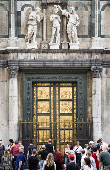 ITALY, Tuscany, Florence, "Tourists in front of the 15th Century East Door of the Baptistry by Lorenzo Ghilberti, given the name The Gate of Paradise by Michelangelo"