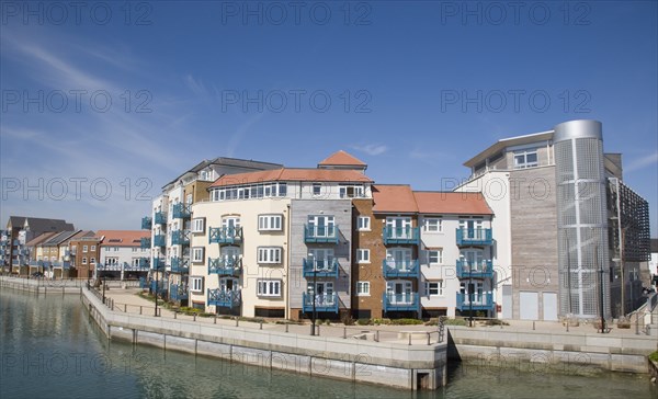 ENGLAND, West Sussex, Shoreham-by-Sea, Ropetackle modern housing development apartments on the banks of the river Adur seen from the Norfolk bridge. A regenerated brownfield former industrial area.