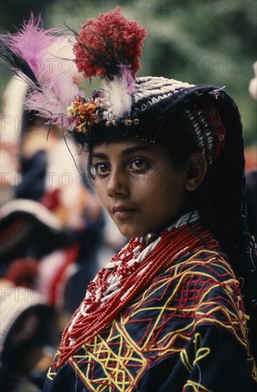 PAKISTAN, North West Frontier, Bumburet, Young Kalash girl wearing traditional dress at the Chilimjusht Festival in Bumburet
