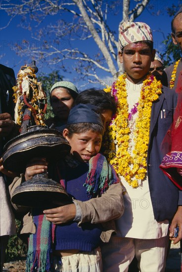 NEPAL, East,  Sangawa Khola, The groom in a wedding procession wearing a marigold garland in the valley of Sangawa Khola