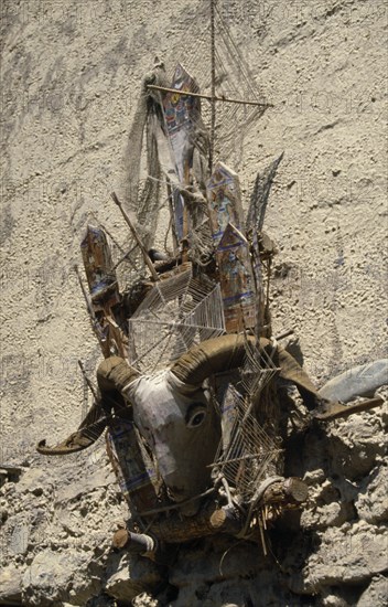 NEPAL, Annapurna Region, Lubra, Circuit Trek. m-do ( animistic devil trap ) hanging above the door to a house in Lubra