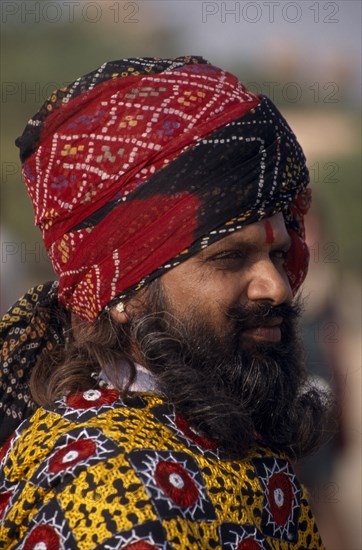INDIA, Rajasthan, Bikaner, Portrait side profile of a Rajput man with a beard wearing a turban at the Camel Festival