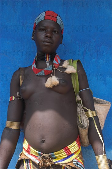 ETHIOPIA, Lower Omo Valley, Key Afir, Tsemay woman traditionally dressed at weekly market