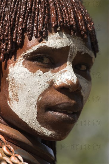 ETHIOPIA, Omo Valley, Mago National Park, "Woman with face painting, her hair greased with ocher colouring and animal fat into plaits known as Goscha"