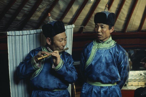 MONGOLIA, Gobi Desert, Biger Negdel, Flute player and chanter in traditional costume during celebrations for the Mongolian Lunar New Year or Tsagaan Tsaar. East Asia Asian Classic Classical Historical Mongol Uls Older