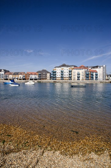 ENGLAND, West Sussex, Shoreham-by-Sea, Ropetackle modern housing development apartments on the banks of the river Adur seen from the opposite bank.. A regenerated brownfield former industrial area.