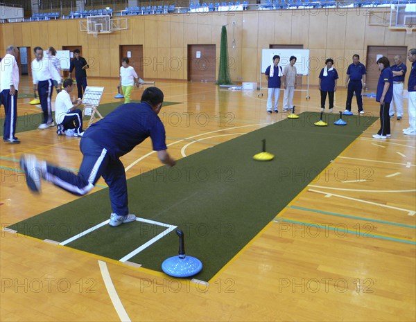 JAPAN, Honshu, Tokyo, "Chiba, Nosaka -at town gym, adults, all over fifty years old, playing unicurl, indoor version of curling, recreation"