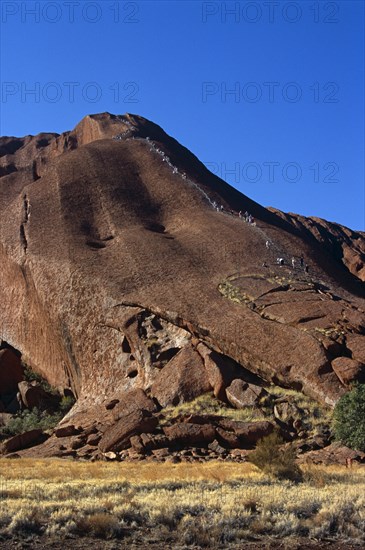 AUSTRALIA, Northern Territory, Uluru, "Kata Tjuta National Park, Mount Uluru, People climbing  Ayers Rock."
