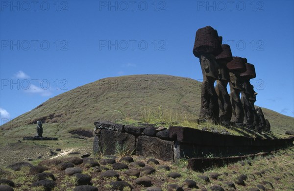CHILE, Easter Island, Anakena, Prehistoric stone heads or moai carved from volcanic rock or tuff and resting on ahus stone burial platforms facing the sea.