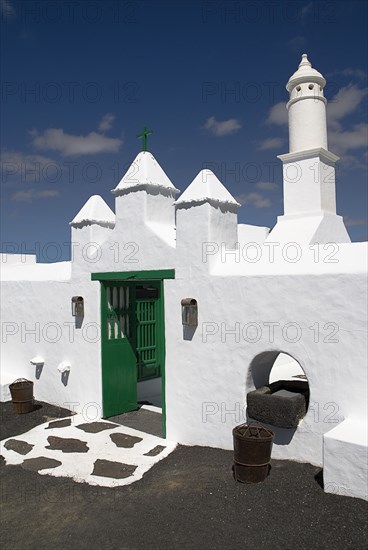 SPAIN, Canary  Islands, Lanzarote, La Casa Museo a La Campesino or the Farmhouse Museum.  Green painted entrance gate to white painted museum complex.