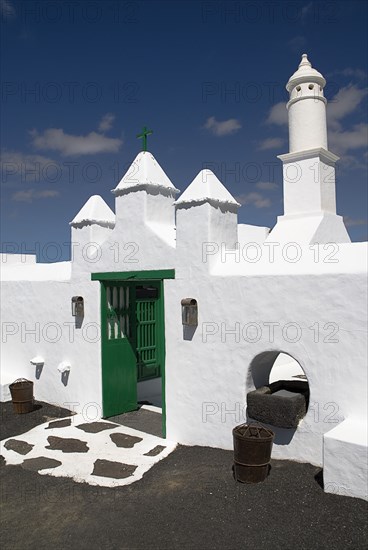 SPAIN, Canary Islands, Lanzarote, La Casa Museo a La Campesino or the Farmhouse Museum. Green painted entrance gate to white painted museum complex.