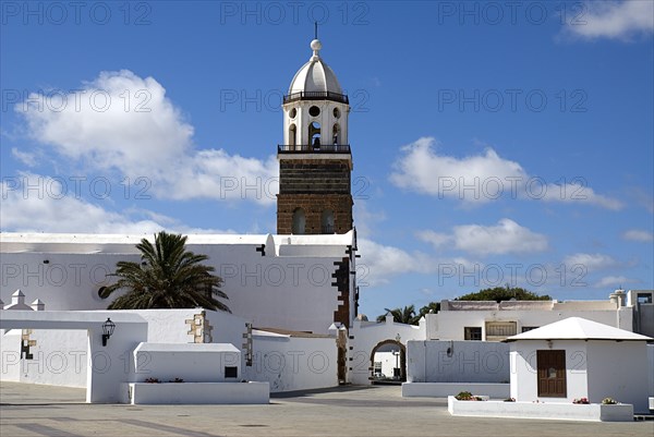 SPAIN, Canary  Islands, Lanzarote, "Teguise, the former capital of the island.  Church of Nuestra Senora de Guadalupe also known as Iglesia de San Miguel white painted exterior and bell tower."