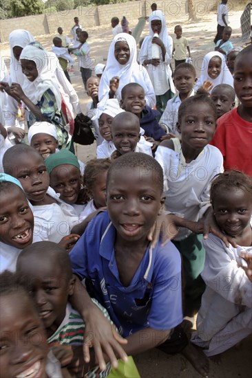 GAMBIA, Western Gambia, Tanji, "Tanji Village.  Happy, laughing children full of energy and wanting to be photographed, trying to get the best position while on a break from lessons at the Ousman Bun Afan Islamic school. "