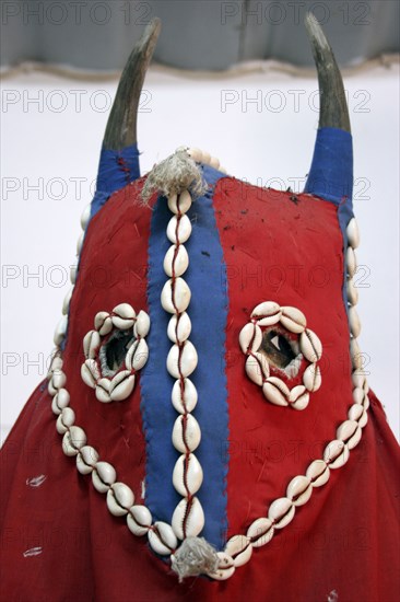 GAMBIA, Atlantic Coast, Banjul, Detail of horned mask of magician’s costume decorated with cowrie shells exhibited at the National Museum of the Gambia.