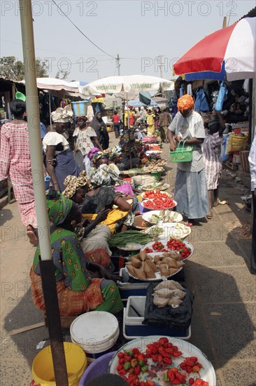 GAMBIA, Western Gambia, Serekunda, "Bakau Market, Atlantic Road.  Busy market scene with women selling fruit and vegetables. "