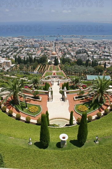 ISRAEL, Northern Coast, Haifa, "Zionism Avenue.  View of Baha'i Shrine and Gardens designed as a memorial to the founder of the Baha’i faith.  Tiered gardens and pathways with palms and cypress trees, central domed shrine and city beyond."