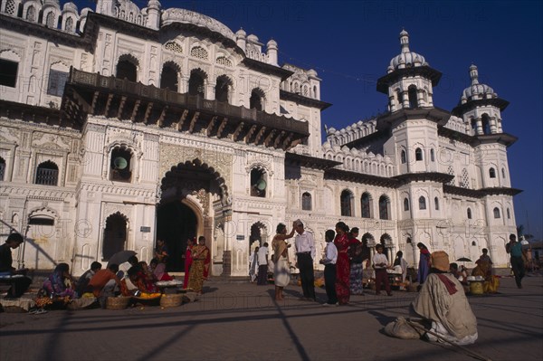 NEPAL, Janakpur, "Janaki Mandir exterior facade with street traders, beggar and crowds in square in the foreground."