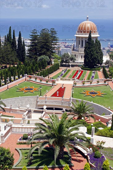 ISRAEL, Northern Coast, Haifa, Zionism Avenue.  View of Baha'i Shrine and Gardens.  Formal layout of flowerbeds and pathways with domed shrine and cypress trees and sea beyond.